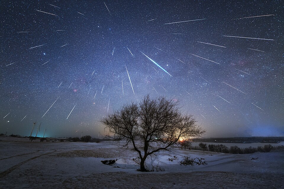Meteors streaking across a starry night sky